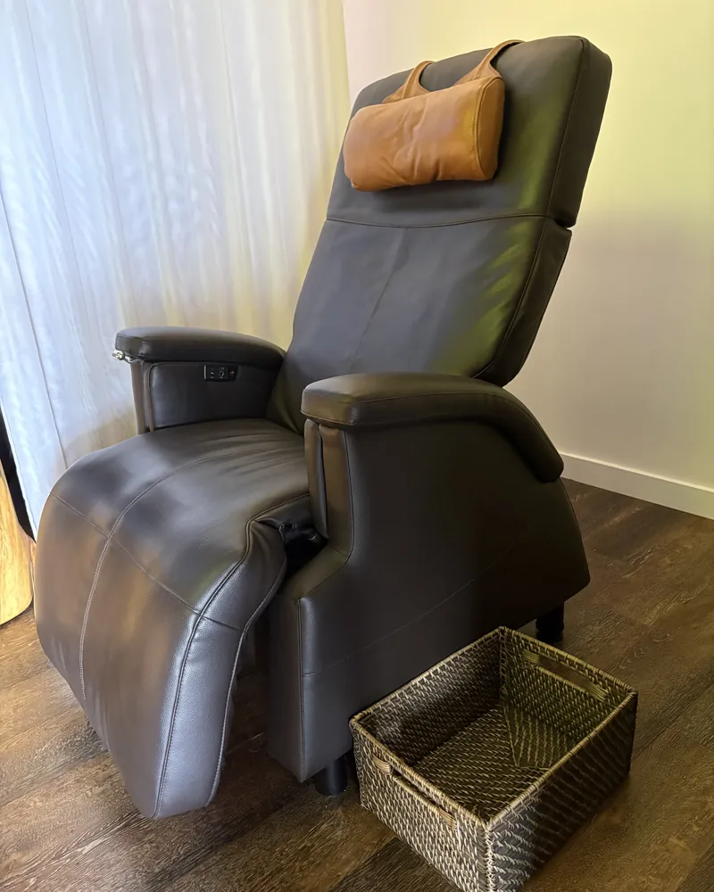 A dark leather treatment recliner beside sheer curtains in The Meridian Room