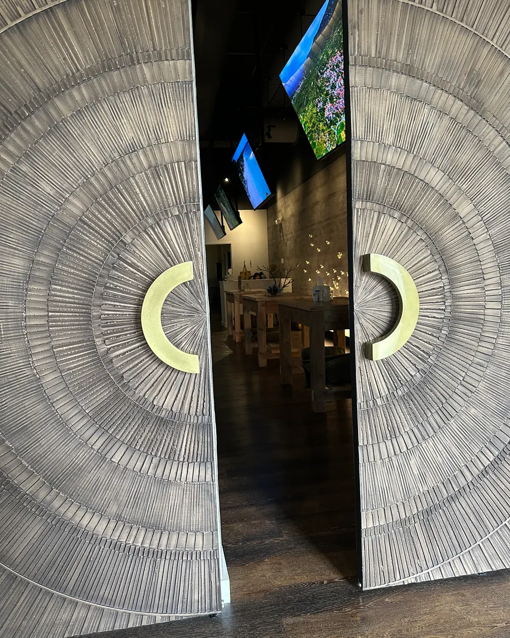 Wooden doors with brass rings opening onto The Meridian Room