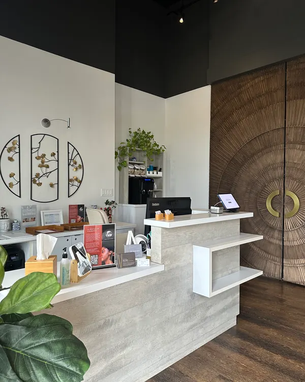 The front desk at Meridian Acupuncture with plants and shelves of products